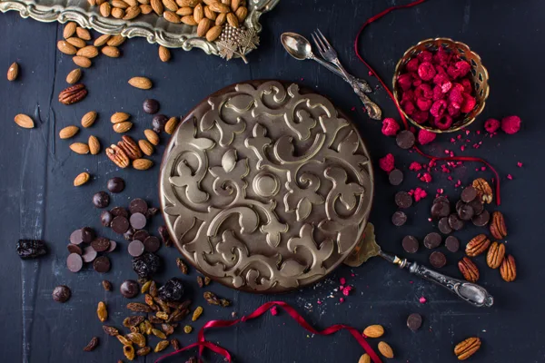 Dark chocolate cake filled with almonds, prunes, apricots and raisins